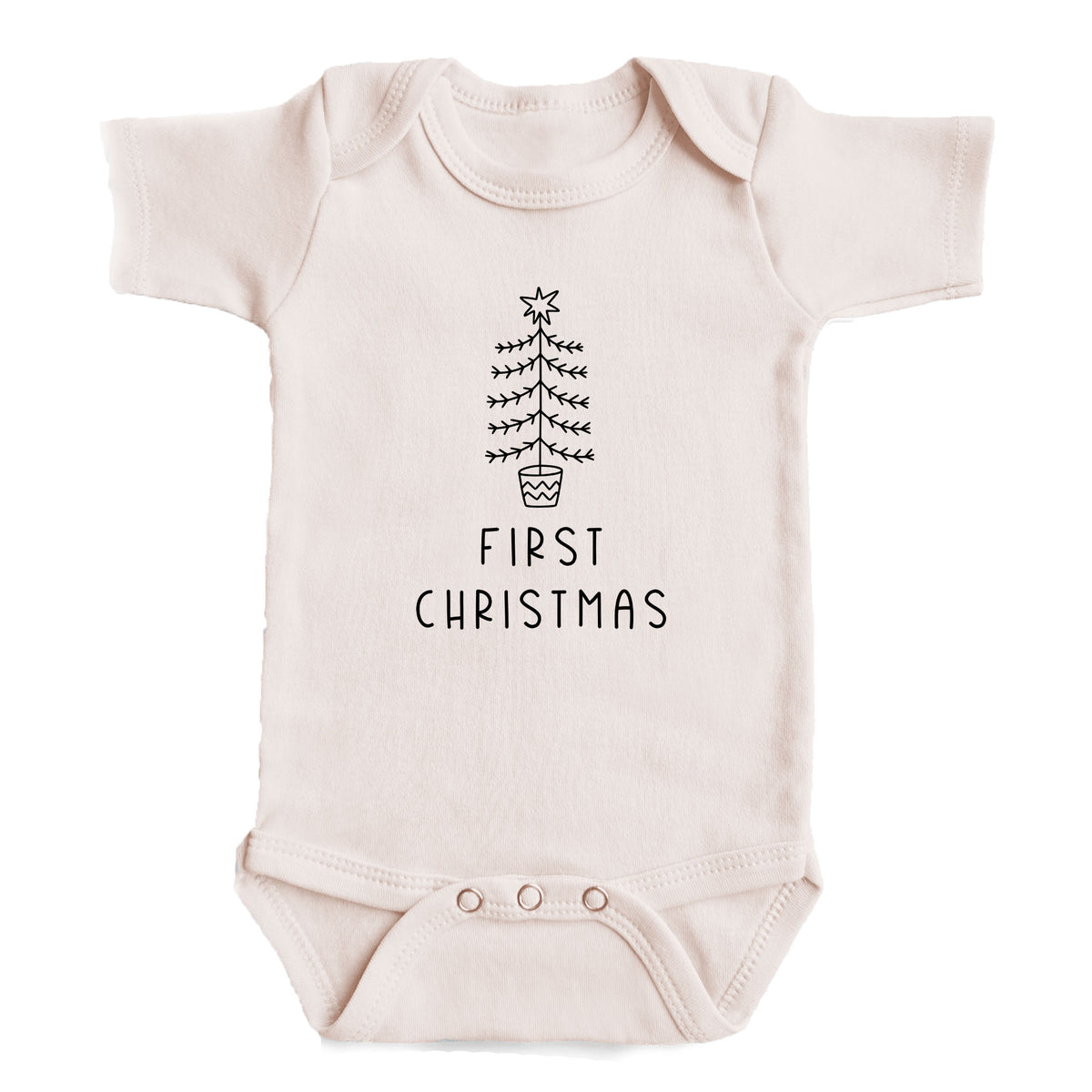 A baby onesie with a Christmas tree design and the text "FIRST CHRISTMAS" printed on it.