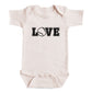 A baby onesie with the word "LOVE" printed on it.