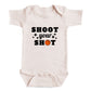 A white baby onesie with the text "SHOOT YOUR SHOT" printed on it.