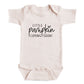 A baby onesie with the text "Little pumpkin coming soon!" printed on it.