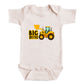 A baby onesie with a graphic of a yellow construction vehicle and the text "BIG BROTHER" printed on it.