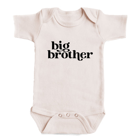 A baby onesie with the text "big brother" printed on it.