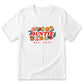 A white t-shirt with a graphic design featuring the word "AUNTIE" surrounded by colorful flowers and leaves. Below the design, the text "est. 2027" is displayed.