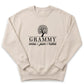 A beige sweater with a graphic design and text printed on it.