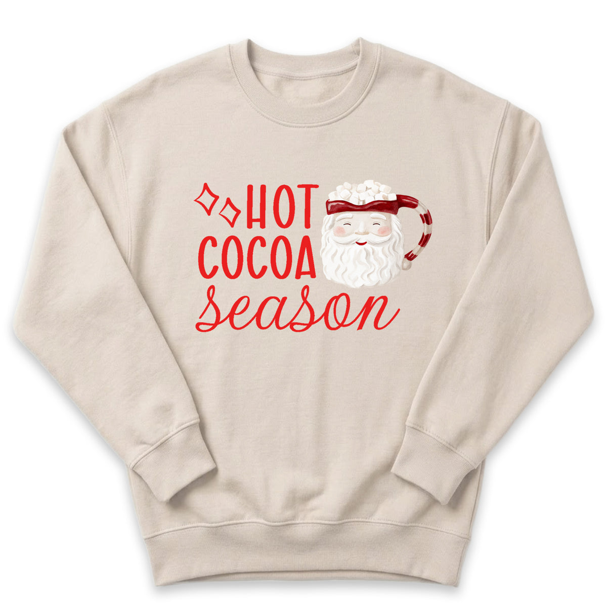 A beige sweatshirt with a red and white design featuring a Santa Claus mug and the text "HOT COCOA SEASON" printed on it.
