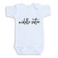 A white baby onesie with the text "middle sister" printed on it.