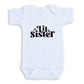 A white baby onesie with the text "Uil sister" printed on it.