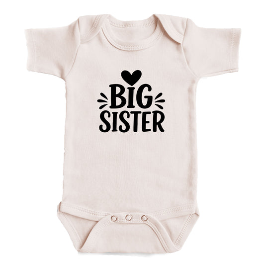 A baby onesie with the text "BIG SISTER" printed on it.