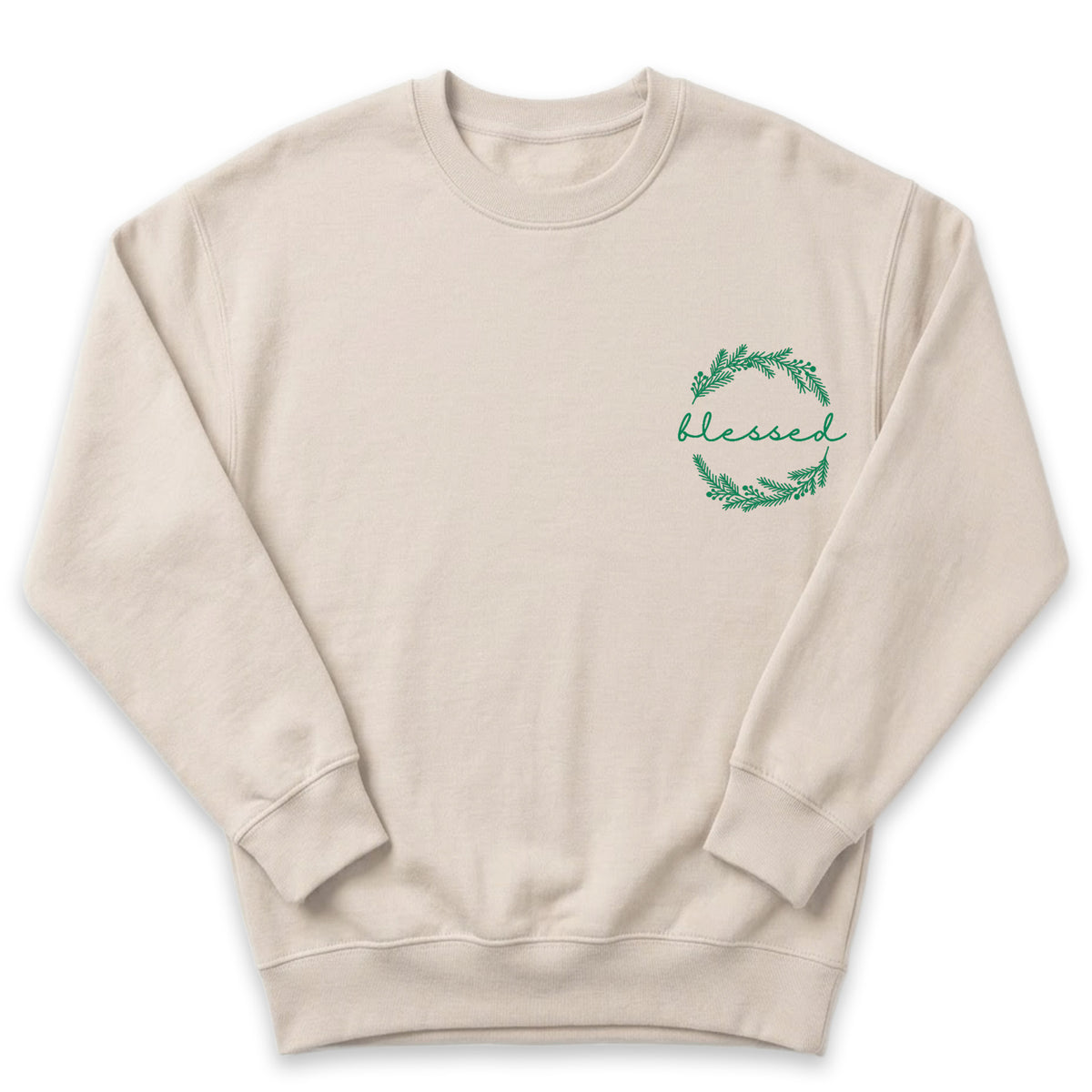 A beige sweatshirt with a green wreath design on the left side and the word "blessed" written in cursive script.